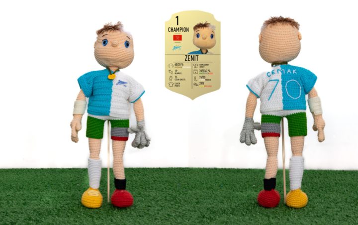 A crocheted football player, in a uniform representing personalized statistics.