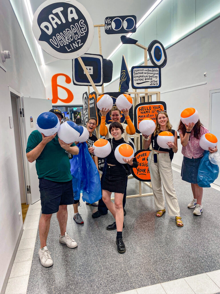 The Data Vandals + students posing with the beach balls of data
