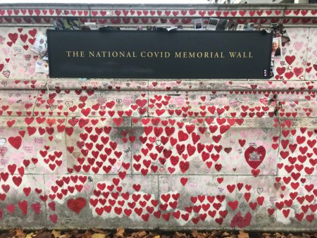 A photo of the wall straight-on, with a sign that says "The National COVID Memorial Wall."