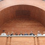 A photo of the attendees who contributed to this article. Dario Rodighiero and students look down from a balcony.