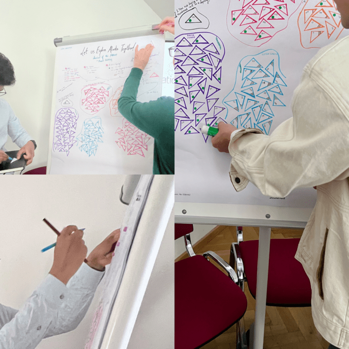 An Image showing the audience interacting with the Data & Design poster and mapping the selected data points onto it.